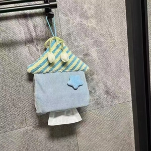 Detail of hanging house-shaped tissue holder with blue star patch and striped knit roof