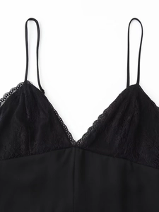 Detailed close-up of a black lace patchwork satin camisole dress with thin straps
