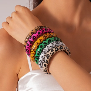 Close-up of colorful leopard print acrylic bangles with bamboo-style jointed design