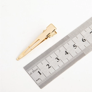 Golden metal hair clip for women, 4.5cm length measurement on white background