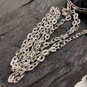 Close-up of a glossy silver metal chain strap for a luxury sequined evening clutch bag