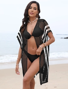 Detail of black crochet beach cover-up featuring white side stripes and airy mesh texture