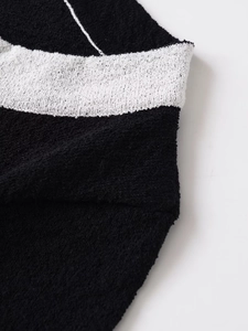 Close-up detail of soft textured contrast wool blend fabric with black and white knit pattern