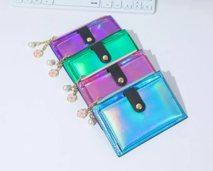 Detail of four holographic PU leather card holders with pearl flower pendants