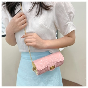 Detailed view of pink cylinder jelly bag with gold chain strap and quilted pattern