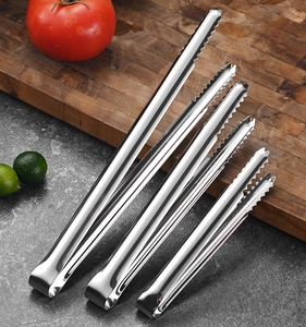 Detail of five SUS304 stainless steel food tongs with serrated heads on a dark table