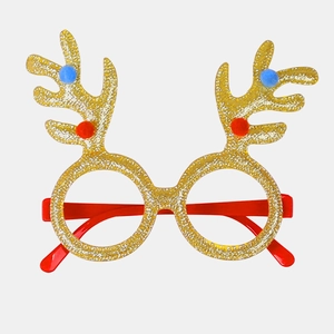 Close-up of glittery reindeer antler glasses with red and blue pom-poms for Christmas
