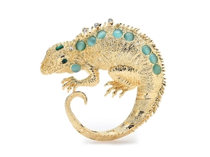 Close-up of golden lizard brooch with green feline eye stones and sparkling rhinestones
