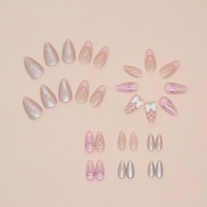 Pink almond press-on nails with 3D bows, French tips and glitter in a flat lay set