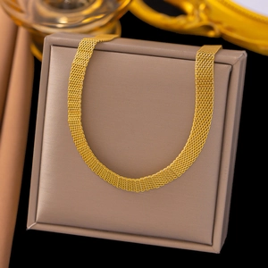 Detailed view of a gold mesh woven necklace elegantly displayed in a beige jewelry box