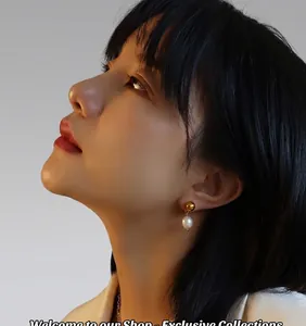 Elegant freshwater pearl drop earrings with gold studs worn by model on dark background