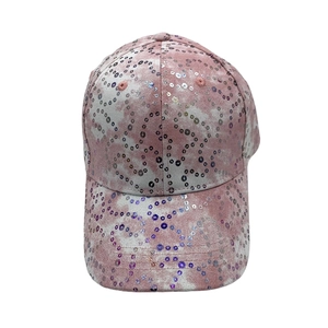 Detail of pink tie-dye baseball cap featuring shiny sequins and durable stitched brim
