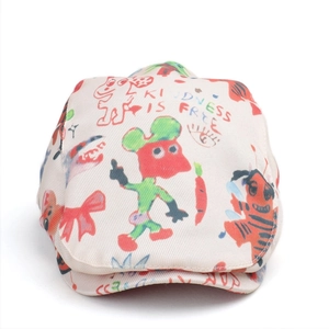 Detail of canvas beret featuring colorful hand-drawn graffiti and kindness lettering