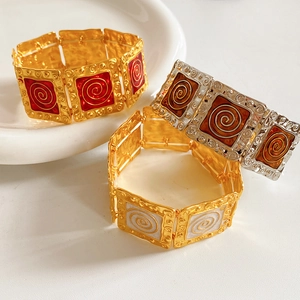Detailed view of vintage enamel square link bracelets in gold and silver finishes