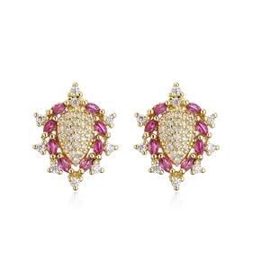 Detail of 18K gold-plated earrings with pear-shaped cubic zirconia and red marquise gems
