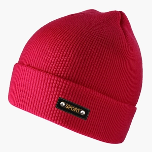 Detail of rose red ribbed knit beanie featuring sport label with metal rivets