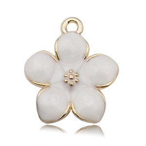Macro detail of a white enamel cherry blossom flower charm with golden metal finish
