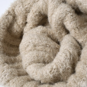 Chunky beige bouclé knit beanie hat with soft wool texture for winter warmth
