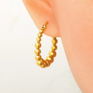 Close-up of 18k gold plated stainless steel hoop earring with small bead link design