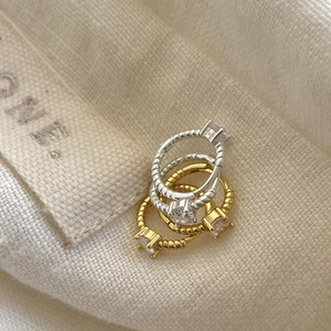 Three-piece twisted rope ring set with round cubic zirconia in silver and gold finish
