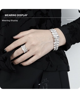 Close-up of pleated S925 sterling silver ruffled cuff bracelet and matching ring on wrist