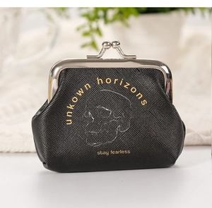 Close-up of black skull coin purse with stay fearless print and metal clasp closure