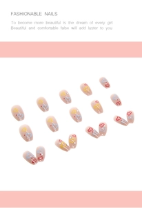 Close-up of pink press-on nails with colorful hand-painted heart patterns in square shape