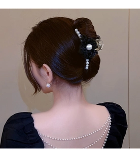 Elegant pearl tassel hair claw clip with black flower design shown on model hair