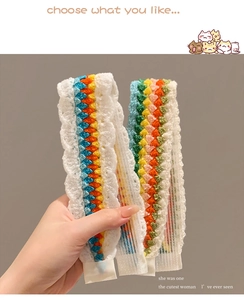 Detail of handmade crochet rainbow headband with white lace trim for girls fashion