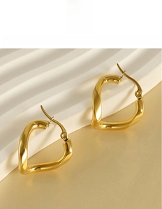 Detailed macro of gold-plated titanium steel twisted heart earrings with ear hooks