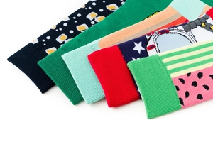 Detailed view of colorful socks with geometric and floral patterns on white background
