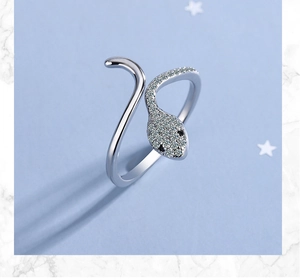 Detailed close-up of a silver snake ring with sparkling diamonds and black stone eyes