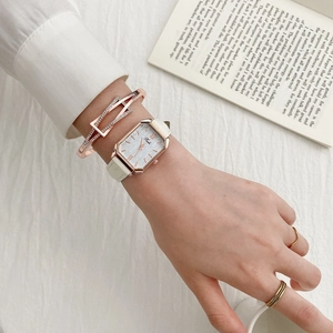 Elegant rose gold rectangular watch with white leather strap and matching jewelry set