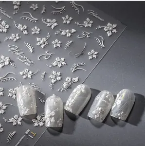 Macro detail of 5D white floral hibiscus nail stickers with elegant 3D relief texture