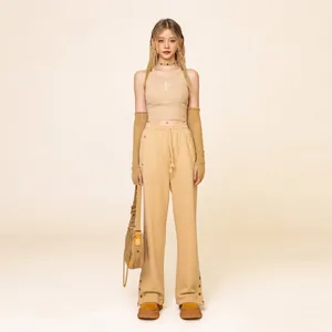 Beige three-piece sporty set with halter top, drawstring wide-leg pants and arm sleeves