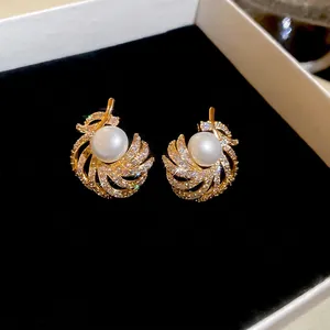 Elegant 18k gold plated pearl drop earrings with spiral crystal feather design in box