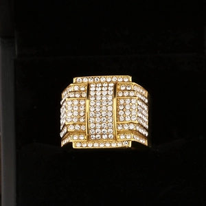 Close-up of hip hop gold square ring with iced out micro pave zircons on black display box