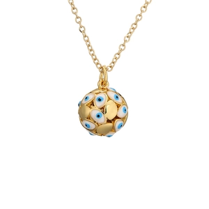 Macro shot of a golden sphere pendant necklace featuring blue and white evil eye enamel details