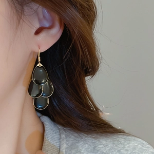 Detailed side view of multi-layer black waterdrop tassel earrings with gold-plated edges