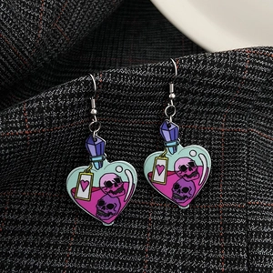 Halloween heart drop earrings featuring gothic skull illustrations on a grey checkered fabric