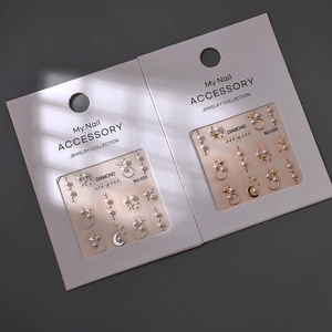 Detail view of 3D pearl and gold star nail art stickers with elegant light and shadow