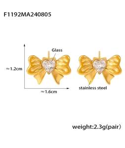 Detailed view of gold plated stainless steel bow earrings with heart glass stone setting