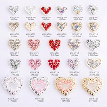 Detailed catalog of 24 heart-shaped nail alloy charms with rhinestones and pearls