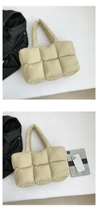 Detailed view of beige quilted down tote bag showing large capacity for a tablet device