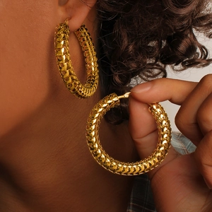 Chunky gold hollow hoop earrings with textured woven metal design in 18K stainless steel