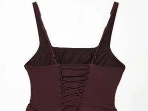 Detail of burgundy evening gown with lace-up back design and metallic eyelets