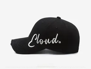 Detail of the white Cloud letter embroidery and distressed edges on the black cotton cap