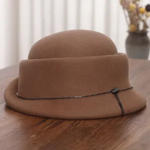 French vintage brown wool cloche hat with black crystal chain on elegant wood surface
