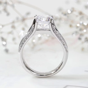 Macro detail of a luxurious four-prong setting engagement ring with pavé side diamonds