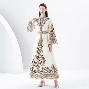 Floral print long maxi dress with stand collar and bell sleeves on a minimalist background